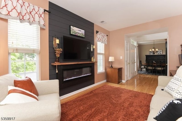 14 Coolidge Way, Montgomery Twp, NJ 08540 - living area with a chandelier, wood finished floors, a large fireplace, and baseboards