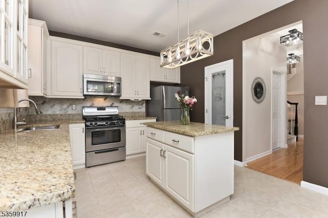 14 Coolidge Way, Montgomery Twp, NJ 08540 - kitchen featuring appliances with stainless steel finishes, a sink, decorative backsplash, and white cabinets