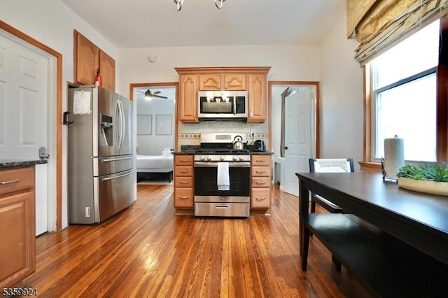 680 N 8th St, Newark City, NJ 07107 - kitchen featuring appliances with stainless steel finishes, backsplash, dark wood finished floors, ceiling fan, and a desk