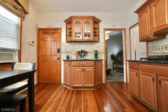 680 N 8th St, Newark City, NJ 07107 - kitchen featuring open shelves, dark wood finished floors, backsplash, glass insert cabinets, and dark stone counters
