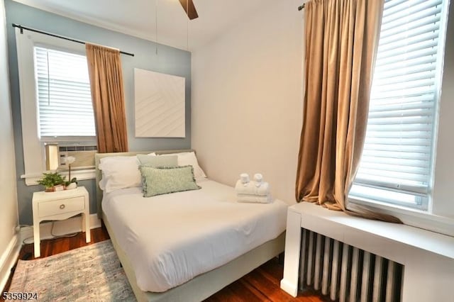 680 N 8th St, Newark City, NJ 07107 - bedroom with radiator heating unit, wood finished floors, and ceiling fan