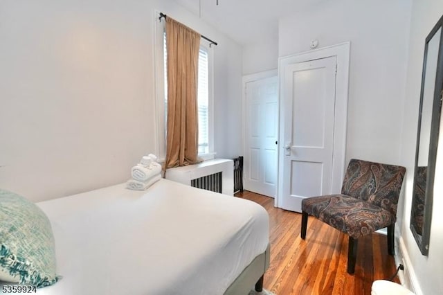 680 N 8th St, Newark City, NJ 07107 - bedroom with radiator heating unit and light wood-style flooring