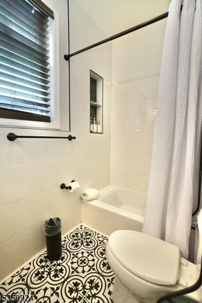 680 N 8th St, Newark City, NJ 07107 - bathroom featuring shower / bath combo with shower curtain and tile patterned flooring