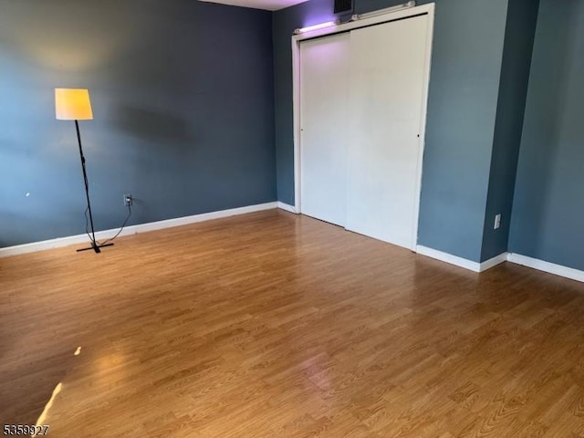 1001 Unicorn Way Unit D2, Clifton City, NJ 07011 - unfurnished bedroom featuring baseboards, wood finished floors, and a closet