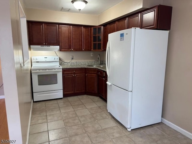 1001 Unicorn Way Unit D2, Clifton City, NJ 07011 - kitchen featuring white appliances, under cabinet range hood, a sink, glass insert cabinets, and baseboards
