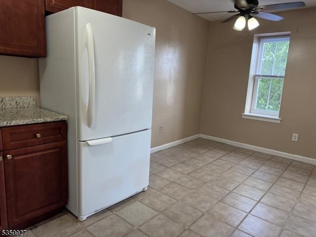 1001 Unicorn Way Unit D2, Clifton City, NJ 07011 - kitchen with freestanding refrigerator, a ceiling fan, baseboards, and light stone counters