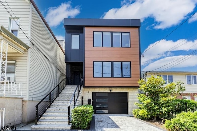 27 Leonard St Unit 2, Jersey City, NJ 07307 - contemporary home with an attached garage, brick siding, and decorative driveway