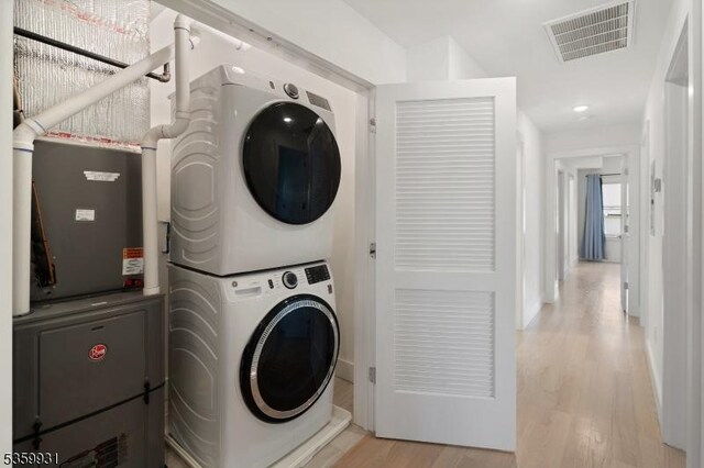 27 Leonard St Unit 2, Jersey City, NJ 07307 - laundry room featuring stacked washer and clothes dryer and light wood finished floors