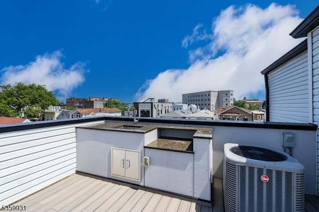 27 Leonard St Unit 2, Jersey City, NJ 07307 - wooden deck featuring a sink and a view of city