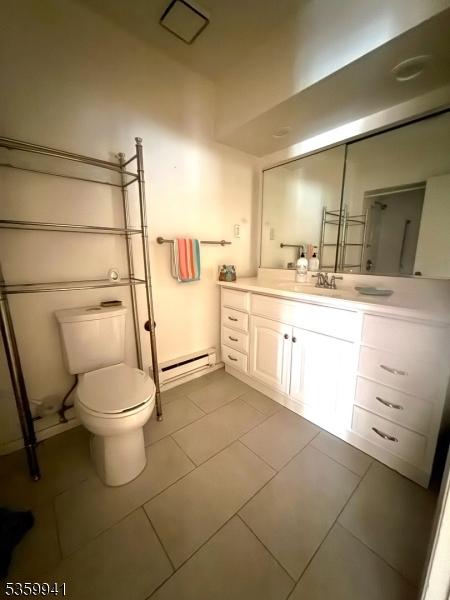 13 Alturas Rd, Vernon Twp, NJ 07422 - bathroom with baseboard heating, toilet, vanity, and tile patterned flooring