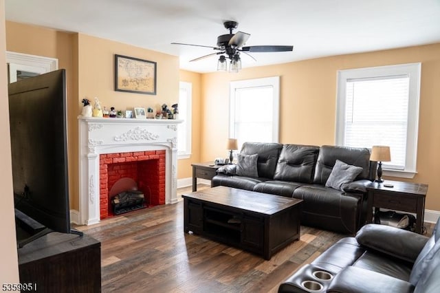 61 Park Ave, Flemington Boro, NJ 08822 - living area featuring dark wood finished floors, a ceiling fan, a brick fireplace, and plenty of natural light