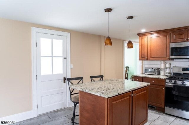 61 Park Ave, Flemington Boro, NJ 08822 - kitchen with appliances with stainless steel finishes, light tile patterned flooring, a kitchen island, a breakfast bar, and recessed lighting