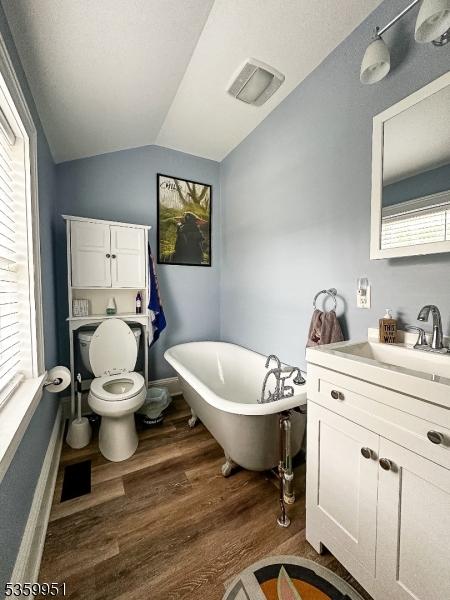 61 Park Ave, Flemington Boro, NJ 08822 - full bathroom featuring a freestanding tub, vanity, wood finished floors, and vaulted ceiling
