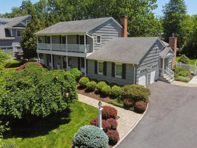 23 Parkview Rd, Chatham Twp, NJ 07928 - view of front facade featuring driveway, a chimney, a shingled roof, and an attached garage