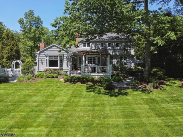 23 Parkview Rd, Chatham Twp, NJ 07928 - view of front of house featuring a pergola, a front yard, a deck, and a chimney