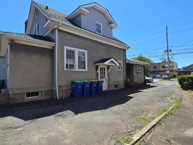 307 W Union Ave, Bound Brook Boro, NJ 08805 - view of home's exterior featuring entry steps, stucco siding, and a shingled roof