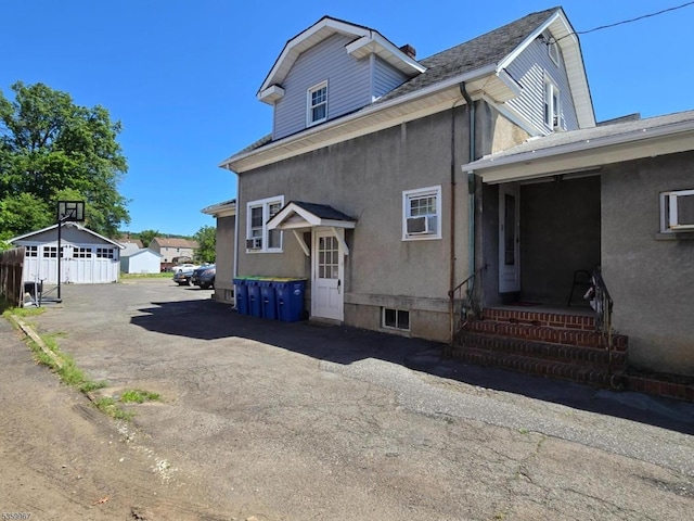 307 W Union Ave, Bound Brook Boro, NJ 08805 - view of side of home with stucco siding and roof with shingles