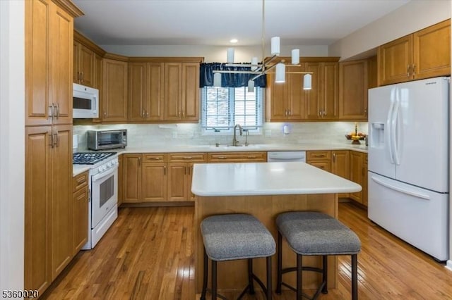 22 Troon Dr, Fredon Twp, NJ 07860 - kitchen featuring white appliances, light wood-style floors, a breakfast bar, tasteful backsplash, and recessed lighting
