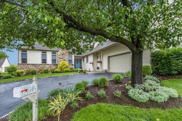 22 Troon Dr, Fredon Twp, NJ 07860 - view of front of house featuring driveway, stone siding, and an attached garage