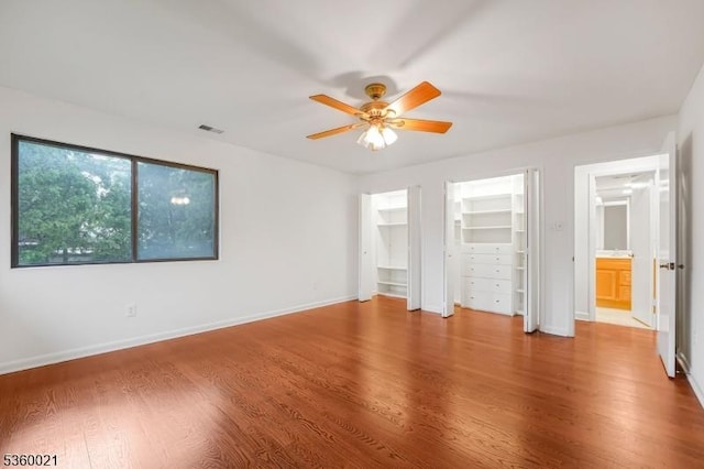 101 River Rd Unit C2, Nutley Twp, NJ 07110 - unfurnished bedroom featuring wood finished floors, baseboards, and multiple closets