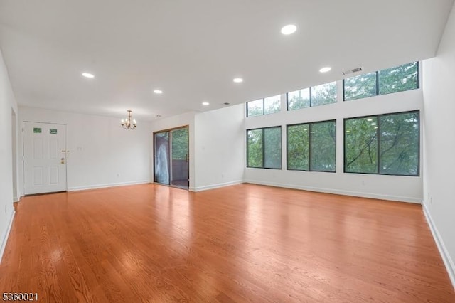 101 River Rd Unit C2, Nutley Twp, NJ 07110 - unfurnished living room featuring a chandelier, recessed lighting, baseboards, and light wood-style flooring