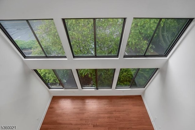 101 River Rd Unit C2, Nutley Twp, NJ 07110 - unfurnished living room featuring a skylight, wood finished floors, and baseboards