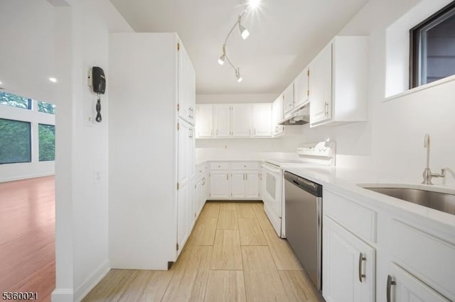 101 River Rd Unit C2, Nutley Twp, NJ 07110 - kitchen featuring dishwasher, under cabinet range hood, stove, white cabinets, and a sink