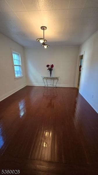 152 Ivy St, Newark City, NJ 07106 - unfurnished dining area with wood finished floors and baseboards