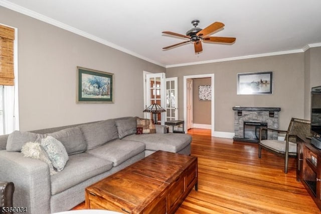 6 Maple Ave, West Orange Twp, NJ 07052 - living area with light wood finished floors, a ceiling fan, crown molding, baseboards, and a stone fireplace
