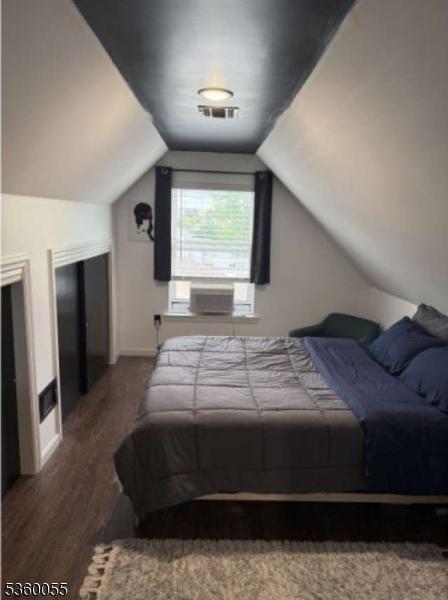 284 W Webster Ave, Roselle Park Boro, NJ 07204 - bedroom with wood finished floors, vaulted ceiling, and baseboards