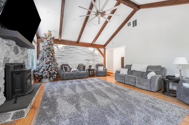 26 Danville Mountain Rd, Liberty Twp, NJ 07838 - living area with high vaulted ceiling, ceiling fan, wood finished floors, beamed ceiling, and a wood stove