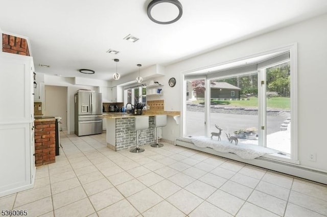26 Danville Mountain Rd, Liberty Twp, NJ 07838 - kitchen with stainless steel fridge, a peninsula, white cabinets, a kitchen breakfast bar, and light countertops