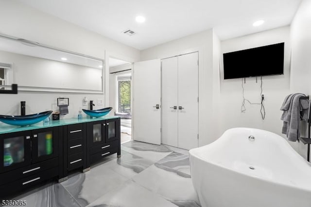 26 Danville Mountain Rd, Liberty Twp, NJ 07838 - bathroom with double vanity, a freestanding tub, marble finish floors, and recessed lighting