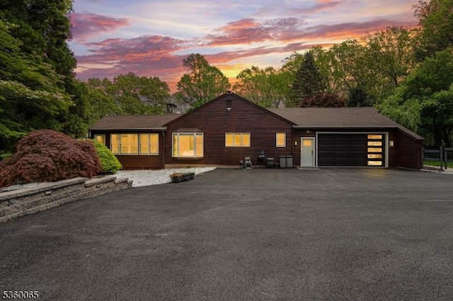 26 Danville Mountain Rd, Liberty Twp, NJ 07838 - view of front of house with asphalt driveway, an attached garage, and view of wooded area