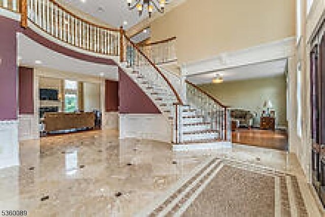 2 Kristina Way, Raritan Twp, NJ 08822 - entryway featuring a high ceiling, stairs, a chandelier, and a wainscoted wall