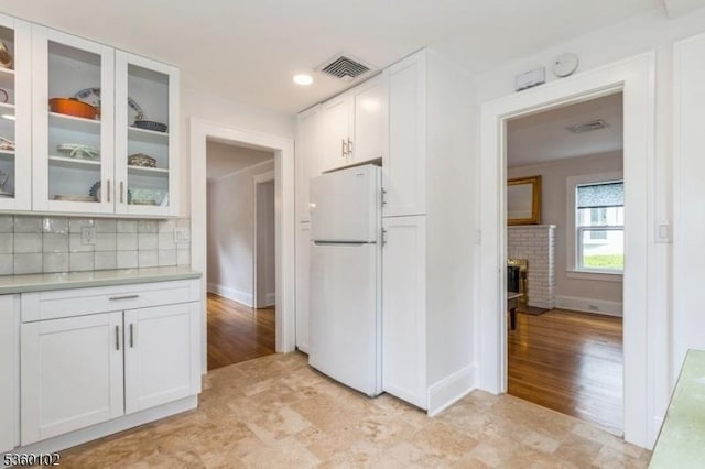 405 High St, Cranford Twp, NJ 07016 - kitchen with freestanding refrigerator, white cabinetry, light countertops, tasteful backsplash, and glass insert cabinets