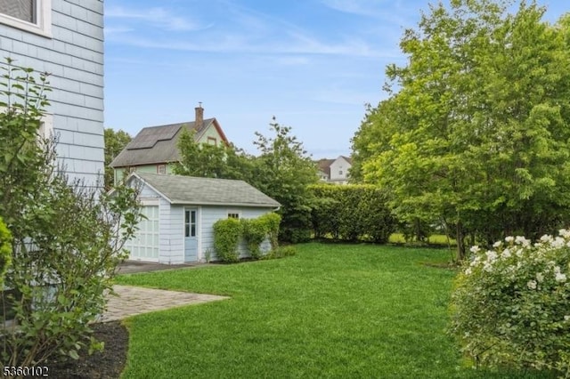 405 High St, Cranford Twp, NJ 07016 - view of green lawn with an outbuilding and a garage