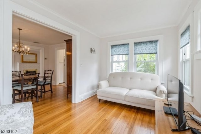 405 High St, Cranford Twp, NJ 07016 - living area featuring light wood finished floors, a chandelier, baseboards, and ornamental molding