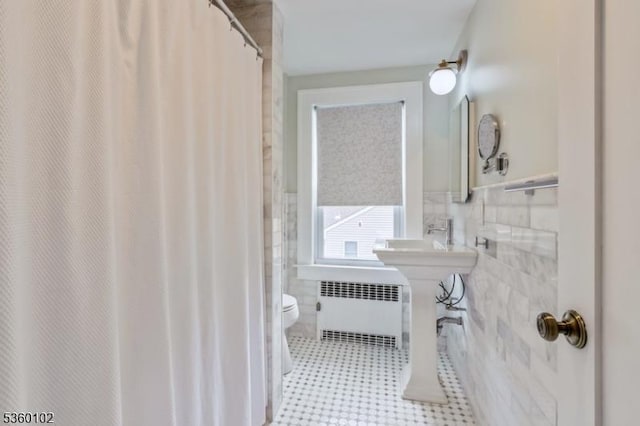 405 High St, Cranford Twp, NJ 07016 - bathroom with radiator heating unit, tile walls, toilet, a wainscoted wall, and a shower with curtain