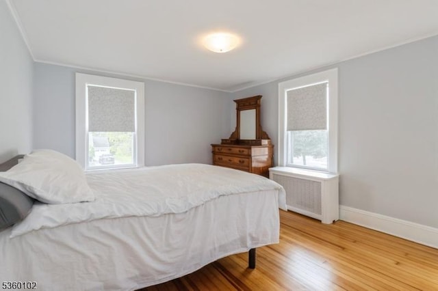 405 High St, Cranford Twp, NJ 07016 - bedroom with radiator heating unit, wood finished floors, multiple windows, ornamental molding, and baseboards
