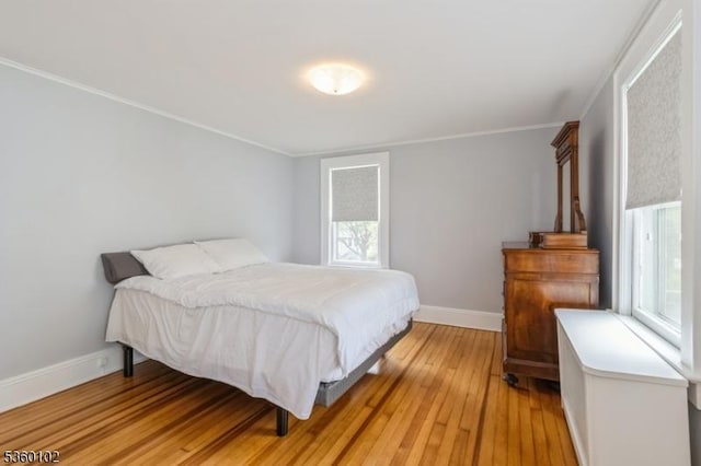 405 High St, Cranford Twp, NJ 07016 - bedroom featuring multiple windows, light wood-type flooring, ornamental molding, and baseboards