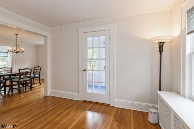 405 High St, Cranford Twp, NJ 07016 - entryway featuring light wood-type flooring, a chandelier, ornamental molding, baseboards, and radiator