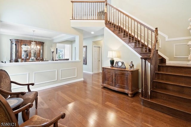 7 Bryant Ct, Franklin Twp, NJ 08873 - staircase featuring wood finished floors, a chandelier, a high ceiling, and baseboards
