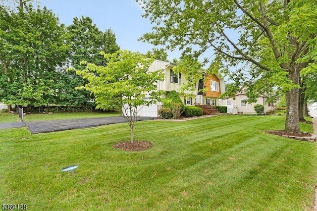 54 Pitman Rd, Parsippany-Troy Hills Twp, NJ 07054 - view of grassy yard featuring driveway and a garage