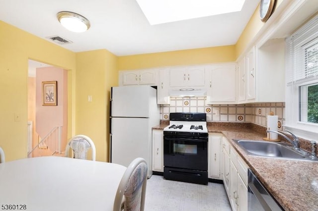 54 Pitman Rd, Parsippany-Troy Hills Twp, NJ 07054 - kitchen with gas range, freestanding refrigerator, under cabinet range hood, a sink, and white cabinets