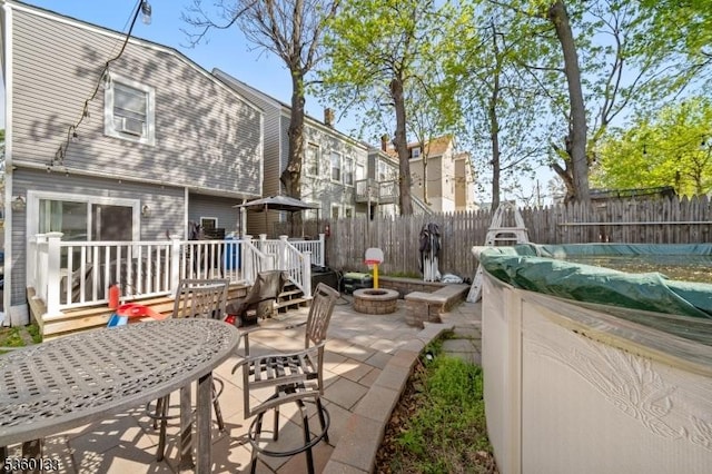 100 N 8th St, Paterson City, NJ 07522 - fenced backyard with a patio, a deck, and a fire pit