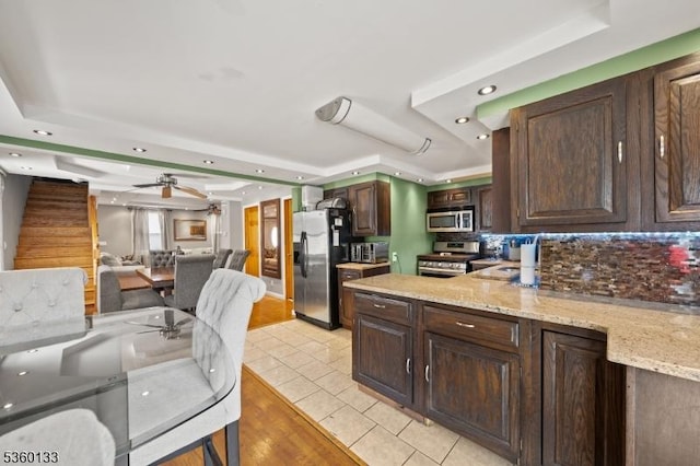 100 N 8th St, Paterson City, NJ 07522 - kitchen with appliances with stainless steel finishes, a raised ceiling, dark brown cabinetry, recessed lighting, and backsplash