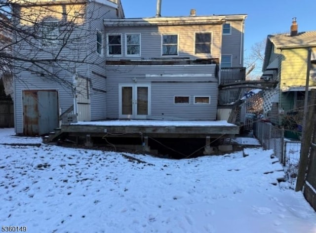 215 Park Ave, Nutley Twp, NJ 07110 - snow covered back of property with a wooden deck and french doors