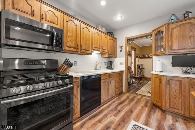 10 Byron Pl, Clifton City, NJ 07011 - kitchen with stainless steel appliances, a sink, light wood-style flooring, light countertops, and brown cabinetry
