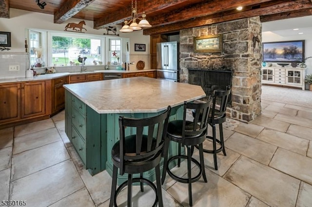 760 Rosemont Ringoes Rd, Delaware Twp, NJ 08559 - kitchen featuring stainless steel appliances, brown cabinets, light countertops, wood ceiling with exposed beams, and a stone fireplace